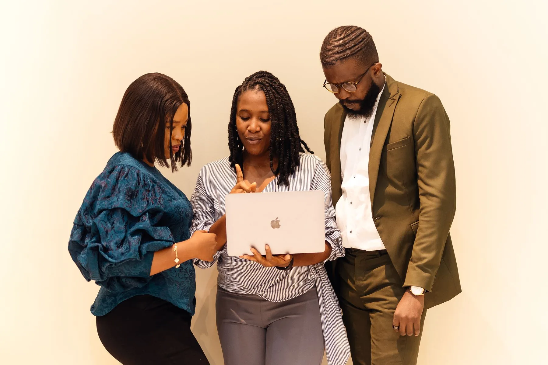 African business team collaborating around a laptop